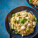 Plate of pasta with mushrooms and spinach.